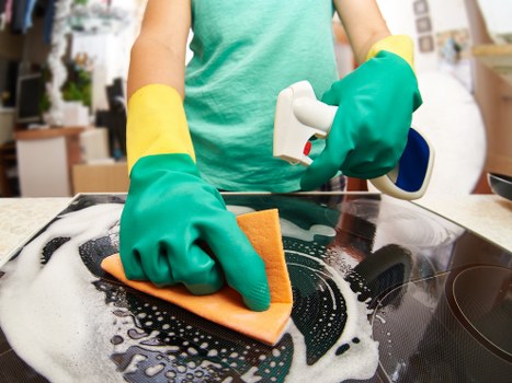 Cleaner Lambeth team member using PPE during a professional cleaning task